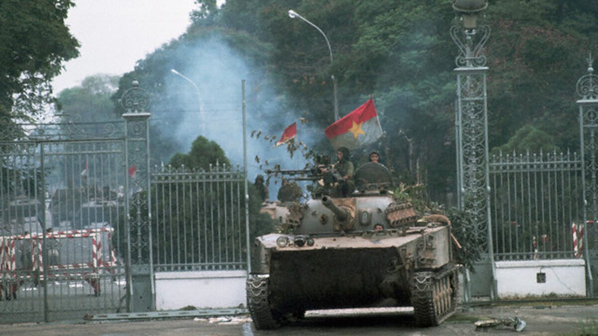 A North Vietnamese tank rolls into a compound during the fall of Saigon, 1975